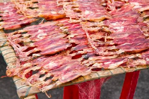 Dried red squid Sun on the grid Stock Photos