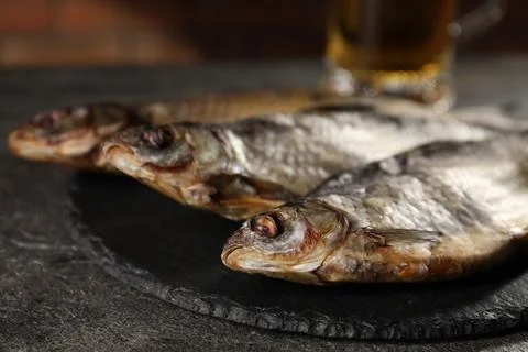 Dried roach fish on grey table, closeup Stock Photos