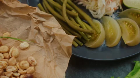 Dried roach with peanuts and pickles on a plate, top view smooth motion 스톡 동영상 250512643
