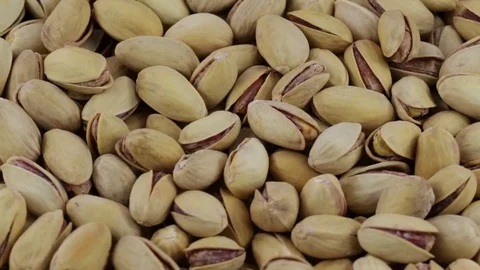 Dried roasted salted appetizing pistachios rotating Stock Footage 75556169