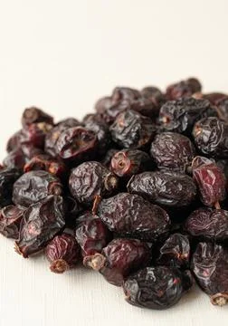 Dried rose hips. Close-up. Macro. Light background. Stock Photos