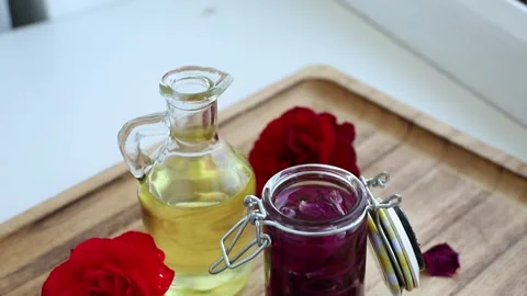 Dried rose petals in a jar to make rose-infused oil at home. Stock Footage 345216963