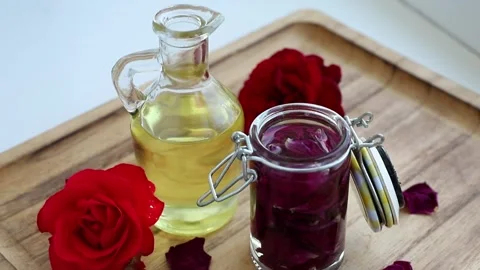 Dried rose petals in a jar to make rose-infused oil at home. Stock Footage 345216991