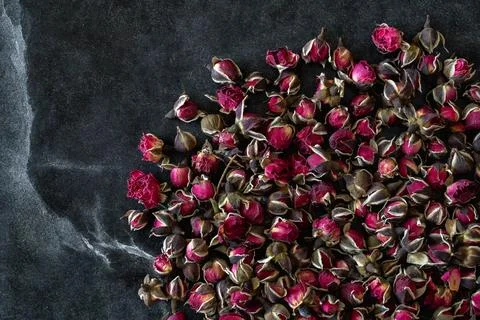 Dried Rosebud Tea on Dark Rustic Background 库存照片