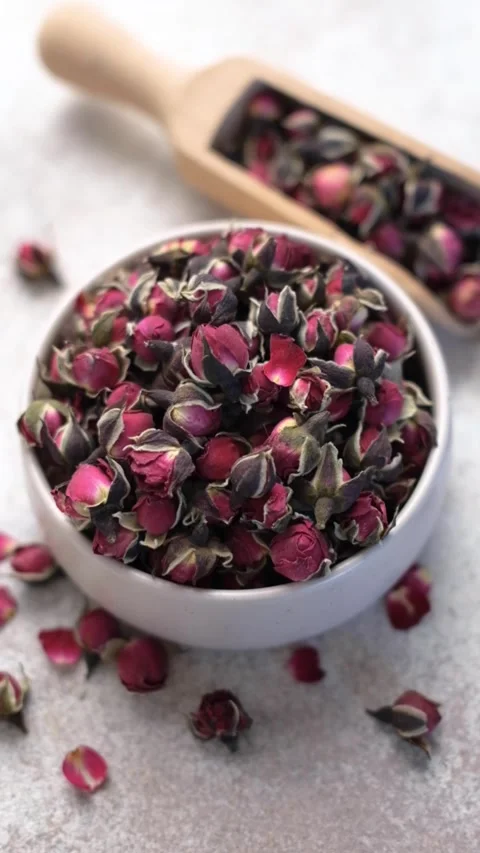Dried rosebuds herbal tea rotating on a concrete background Stock Footage 334136334