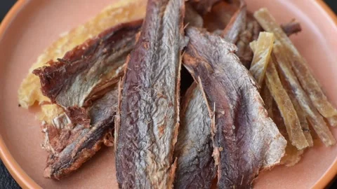 Dried salted fish as snacks or jerky, seafood as slices. Dried seafood snacks Stock Footage 315245671