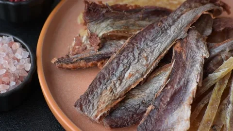 Dried salted fish as snacks or jerky, seafood as slices. Dried seafood snacks Stock Footage 315245672