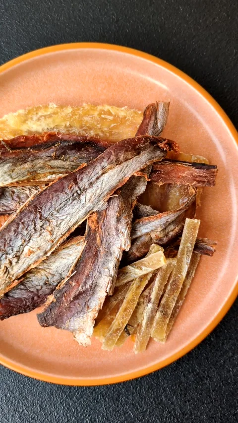 Dried salted fish as snacks or jerky, seafood as slices. Dried seafood snacks Stock Footage 315245705