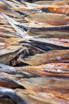 Dried salted fish stacked in rows showing preserved seafood texture and tra.. Stock Photos