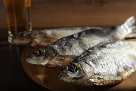 Dried salted roach fish and beer on table, closeup Stock Photos