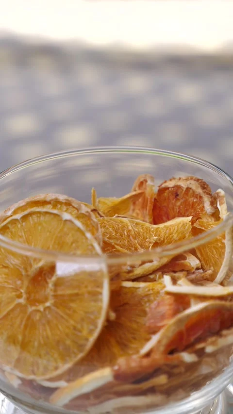 Dried sliced oranges. camera moves around glass vase with dried oranges Stock Footage 314141039