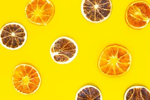 Dried slices citrus pattern on bright yellow background Stock Photos