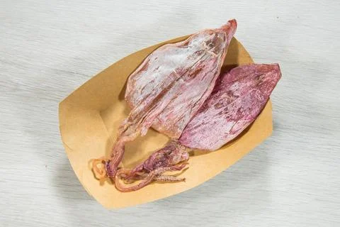 Dried squid in simple paper tray Stock Photos