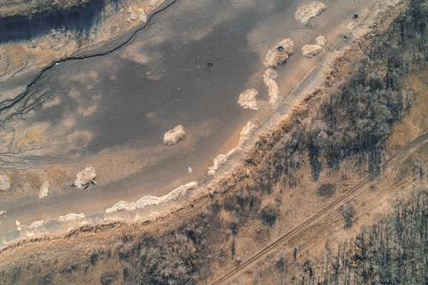 Dried stream bed and parched ground in a desolate landscape, environmental Stock Photos