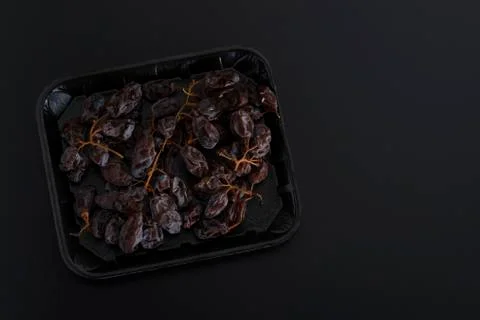 Dried sultanas on a tray isolated on black background Stock Photos