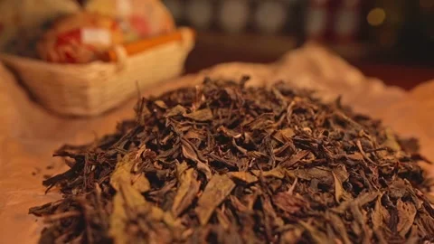 A dried tea leaf lies scattered on paper. Traditionally Chinese tea. Stock Footage 264388842
