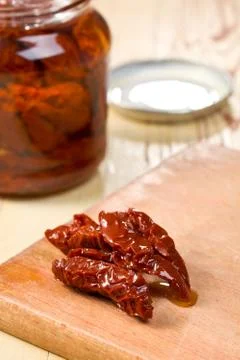 Dried tomatoes on kitchen table Stock Photos