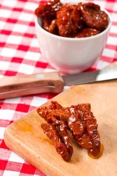 Dried tomatoes on kitchen table Stock Photos