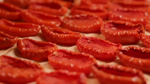 Dried tomatoes on an oven tray. The process of preparing an Italian appetizer Stockbeeldmateriaal 212949406