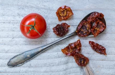 Dried tomatoes on a spoon macro Stock Photos