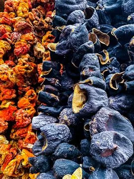 Dried vegetables, tomatoes, eggplant on a string. Turkish market Stock Photos