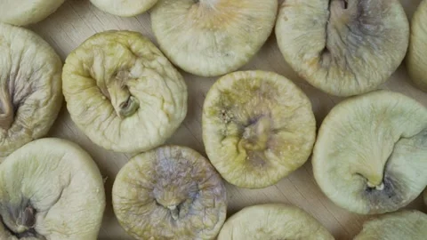 Dried yellow ripe figs fruit rotate on wooden background view from above. Stock Footage 166852907