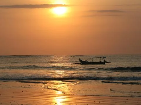 Drifting boat on a sunset Stock Photos