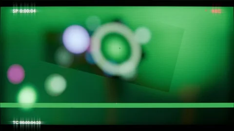 Drifting bokeh ring shifting right in room with small disks, REC light turning Video stock 340268302