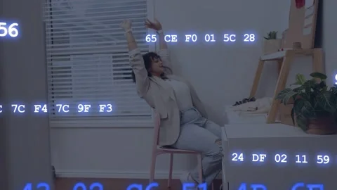 Drifting code overlay causing woman raising arms at desk and manipulating Stock Footage 333552919