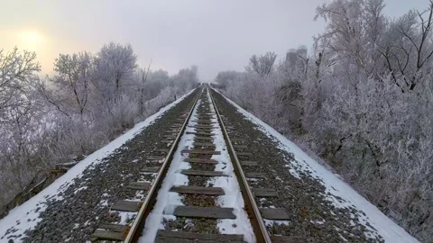 Drifting down railroad tracks and through surreal frosted landscape. Stock Footage 299362916