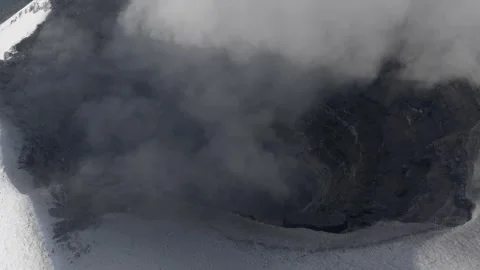 Drifting emissions veil the dark crater interior of Popocatepetl Stock Footage 346251384