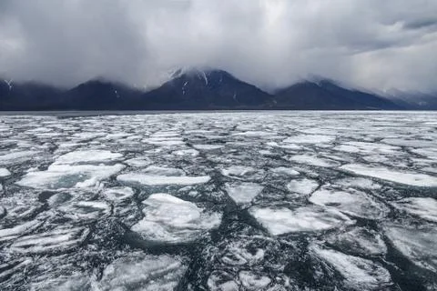Drifting ice blocks on mountain background Stock Photos