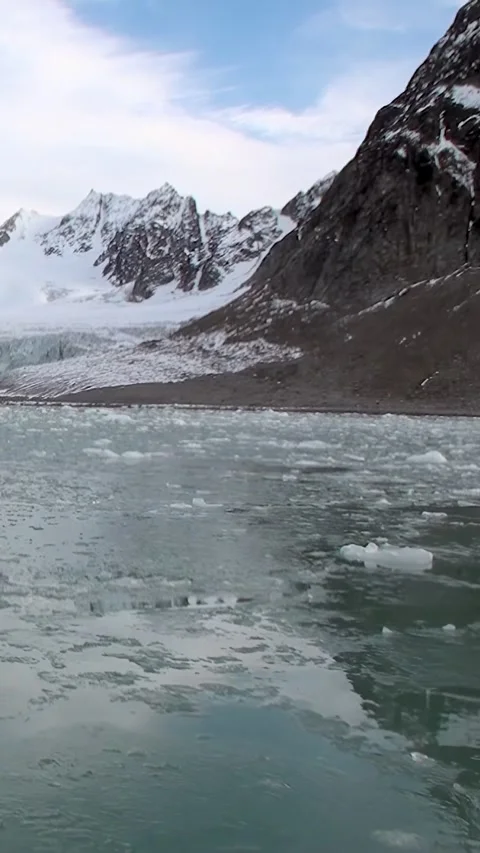 Drifting Ice Floes Against a Backdrop of the Svalbard Glacier Stock Footage 327016171
