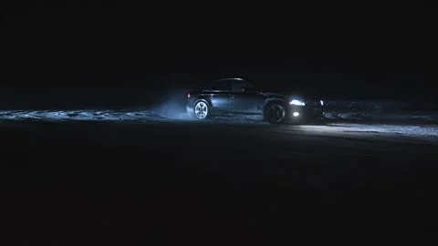 Drifting lights car. professional driver drifting car on snowing night asphalt Stock Footage 219741524