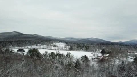Drifting Over Snowy Trees and Mountains Stock Footage 295006489