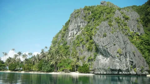 Drifting past limestone cliffs, foliage, and white sand over calm, clear waters. Stock Footage 32187270