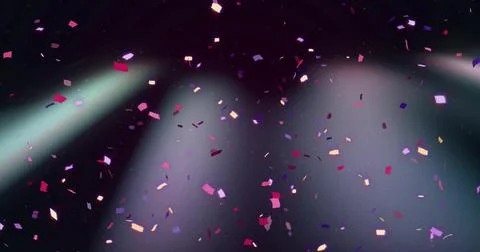 Drifting rectangular colorful confetti on stage, two spotlights cutting haze and Stock Photos