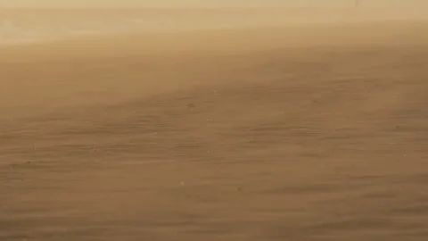 Drifting sand forms ripples on sunbaked desert surface Stock Footage 306750659