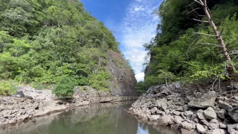 Drifting through the river in a valley Stock Footage 212603055