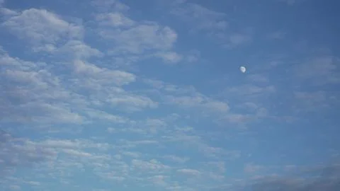 Drifting Wispy Clouds with Daytime Moon in Blue Sky Photos