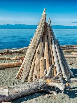 Driftwood Teepee On Beach Stock Photos