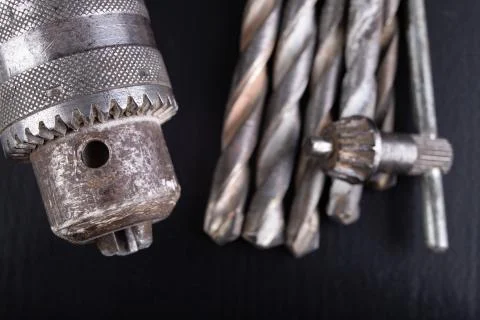 Drill and drills on a workbench. Tools for construction workers. Stock Photos