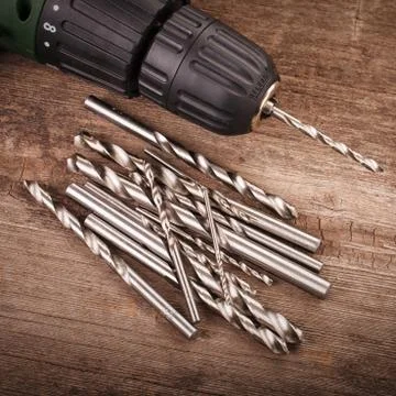 Drill and set of drill bits Stock Photos