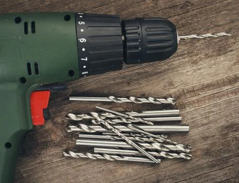 Drill and set of drill bits Stock Photos