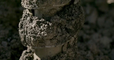 Drill auger filled with mud after drilling into the ground Stock Footage 145282701