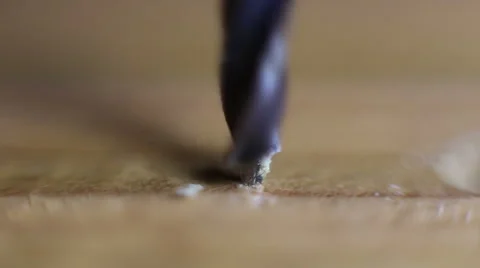 The drill bit is drilling a hole in wood Stock Footage 60592044