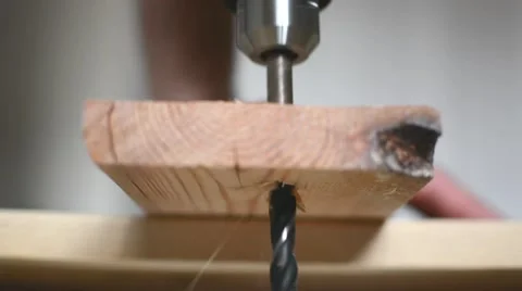 The drill bit is drilling a hole in the wood Stock Footage 61325415