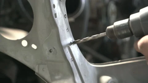 Drill bit drilling through car metal in repair shop Video stock 143449801