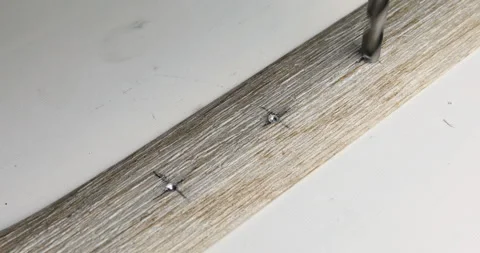 Drill bit drilling through metal plate Stock Footage 108522607