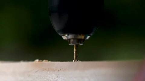The drill bit drills a wooden block. Close-up. Stock Footage 244936071